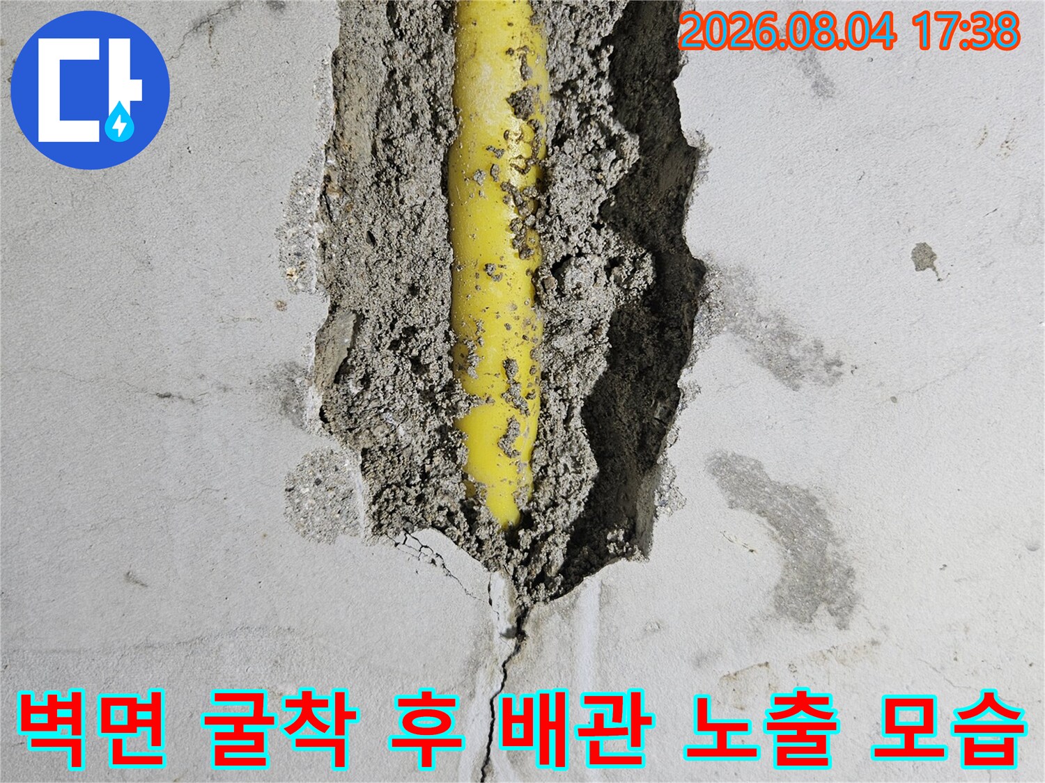 벽을 파고 들어간 뒤 드러난 손상된 노란색 온수 배관 이미지