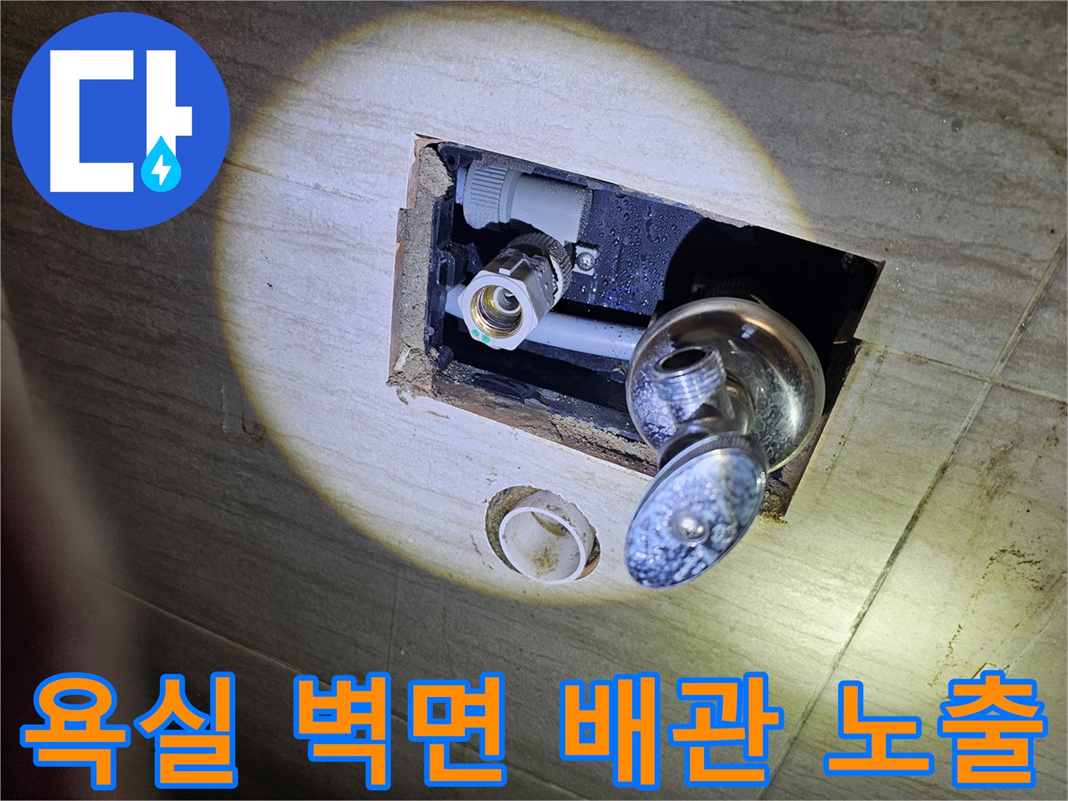 세면대 수전과 연결된 매립형 급수 배관의 근접 촬영