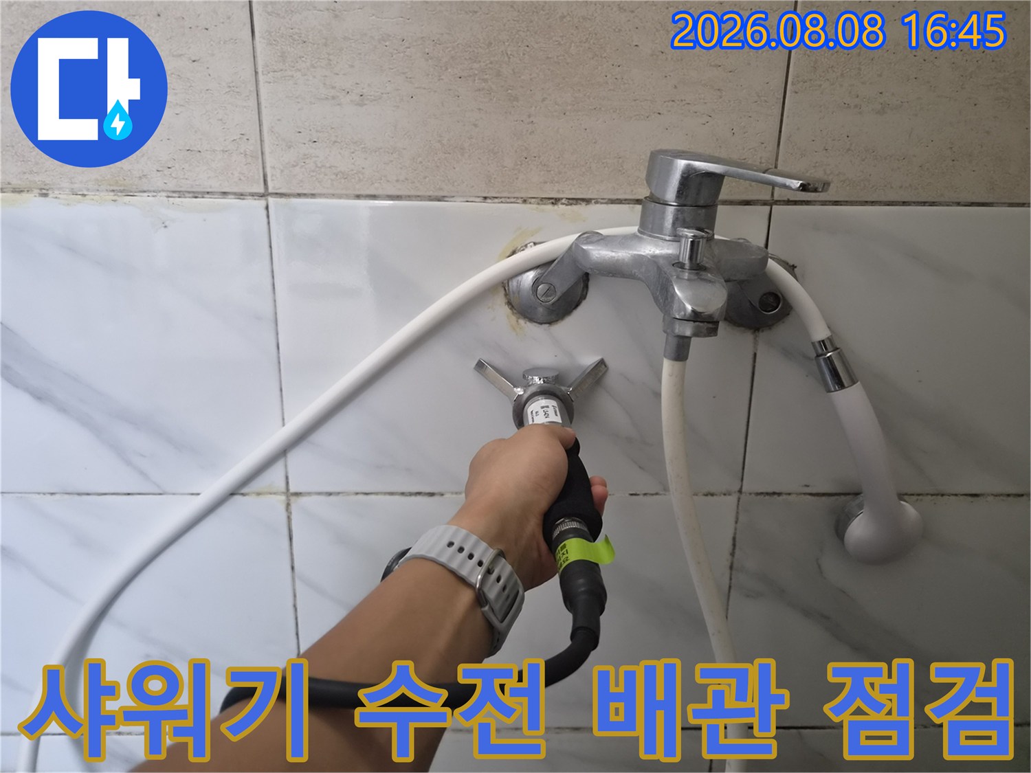 욕실 샤워 수전 연결 부위의 누수 지점을 찾는 작업 모습