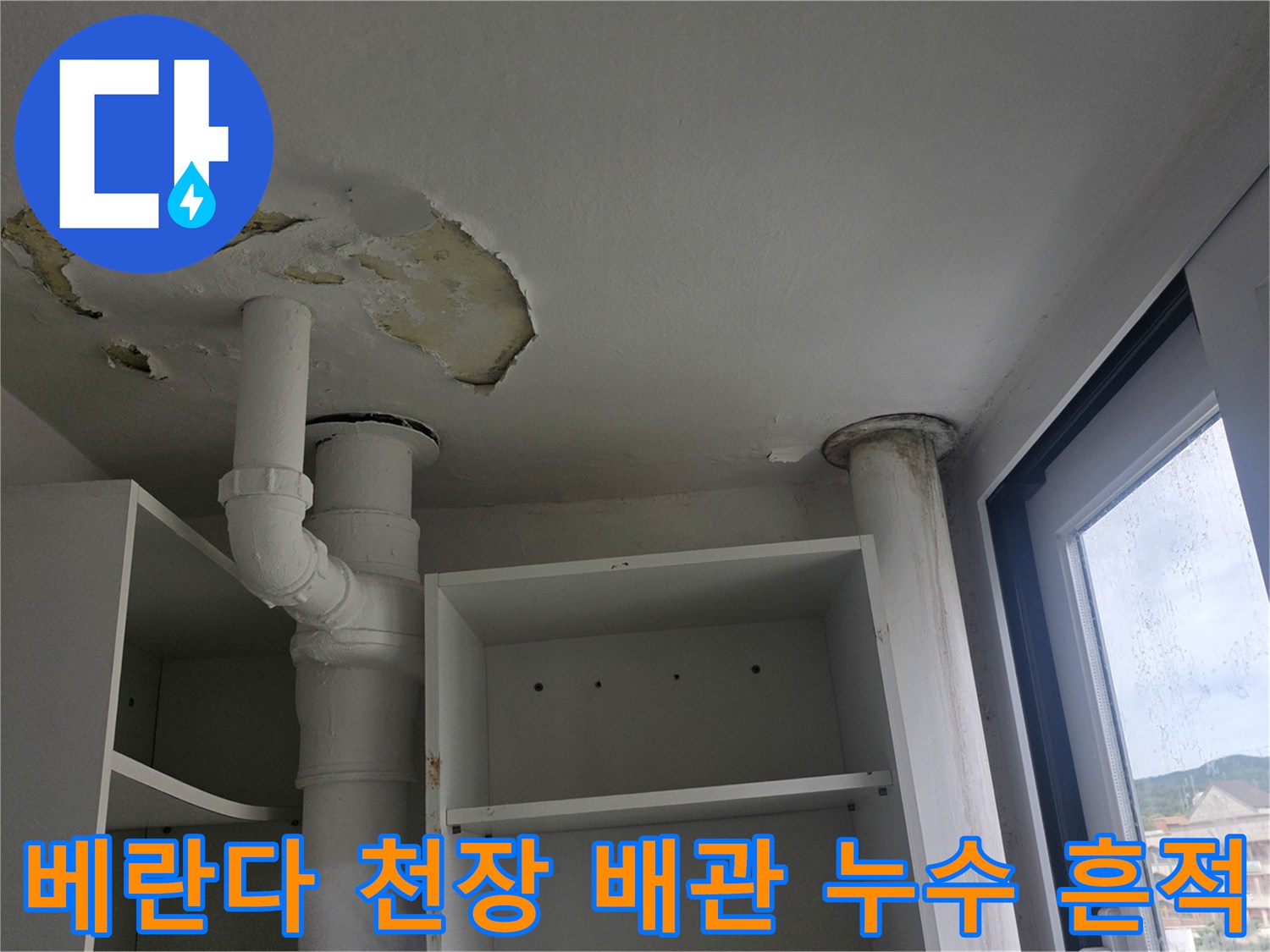 베란다-천장의-흰색-배관-주변으로-마감재가-벗겨지고-누수-얼룩이-남은-모습