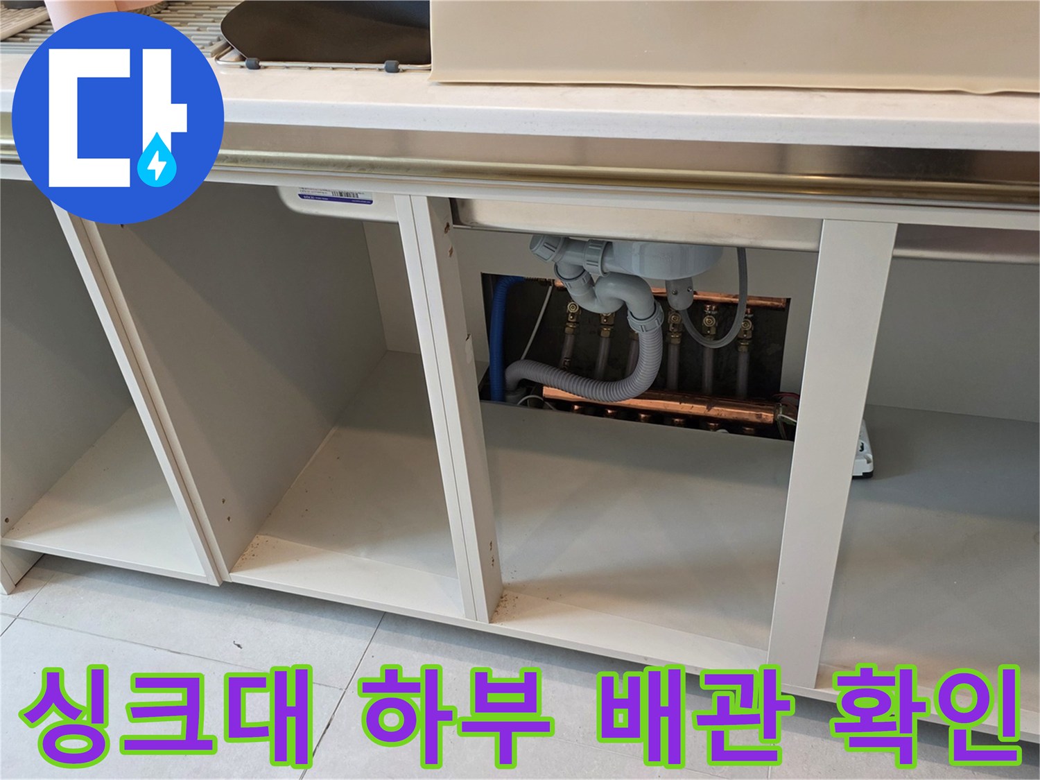 구리 교문동 현장의-싱크대 하부장 내부 배관 상태를 점검하는 모습입니다.