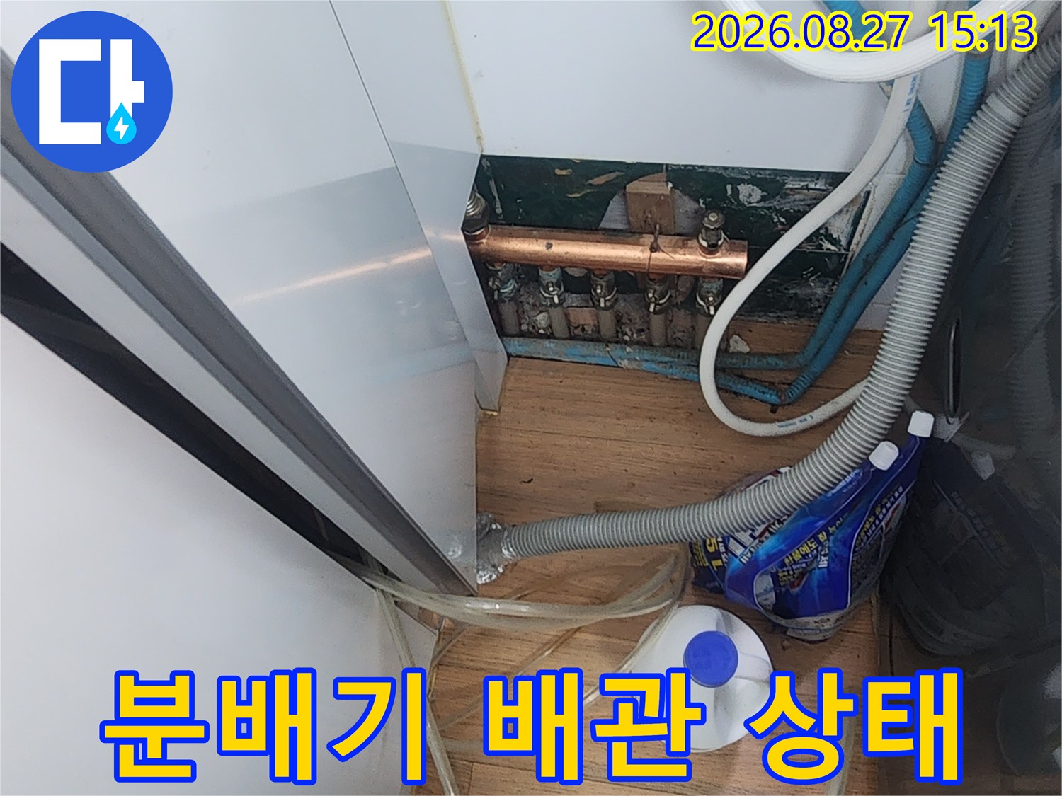 싱크대 하부에 위치한 금속 분배기와 연결 호스들입니다.