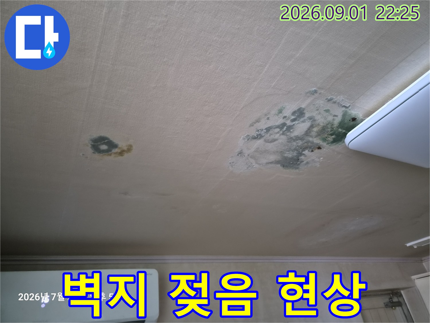 습기로 인해 물에 젖어 얼룩진 거실 천장 벽지 표면