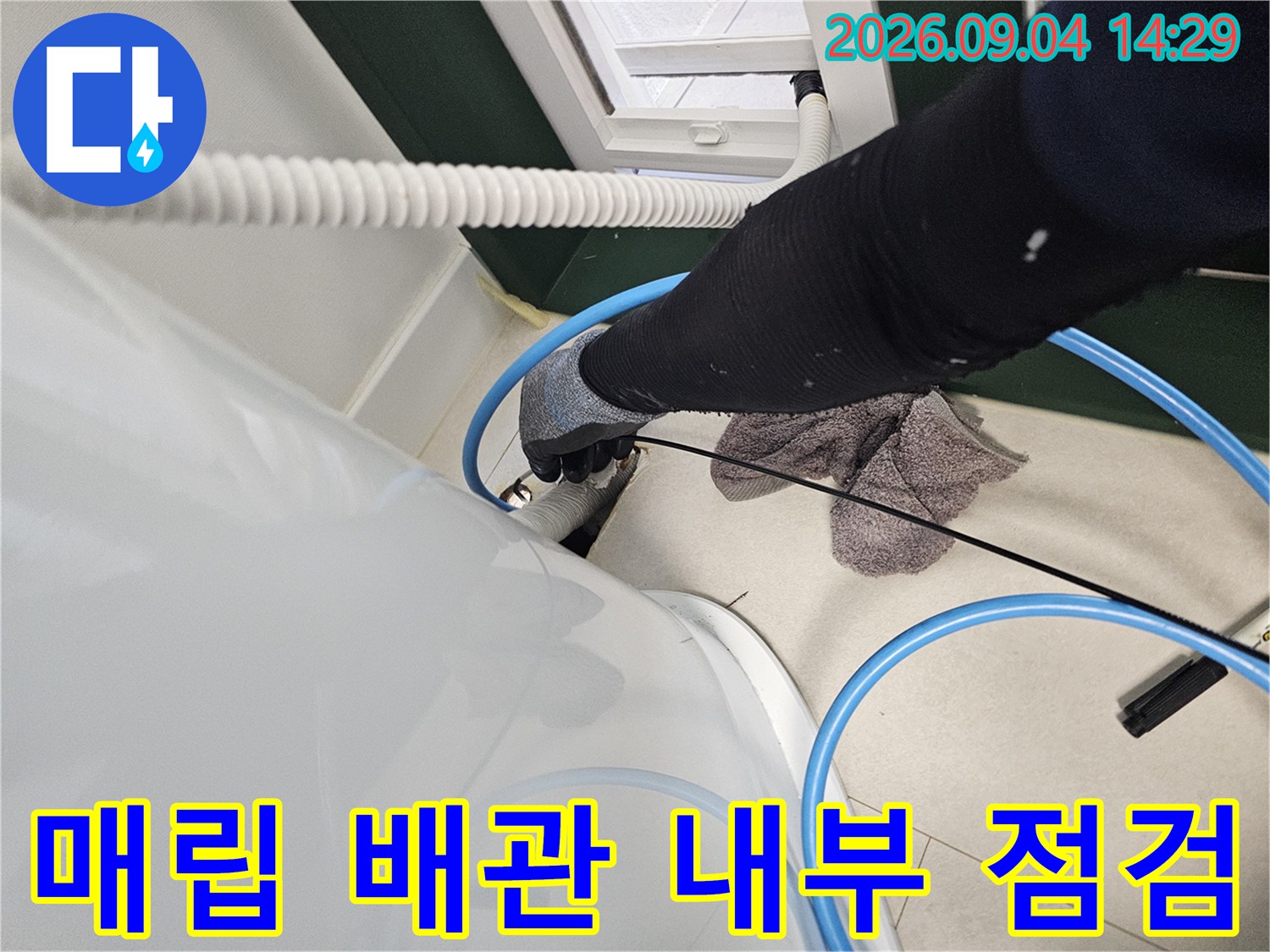 배관 내부에 고인 물을 제거하기 위해 호스를 연결하여 흡입하는 모습
