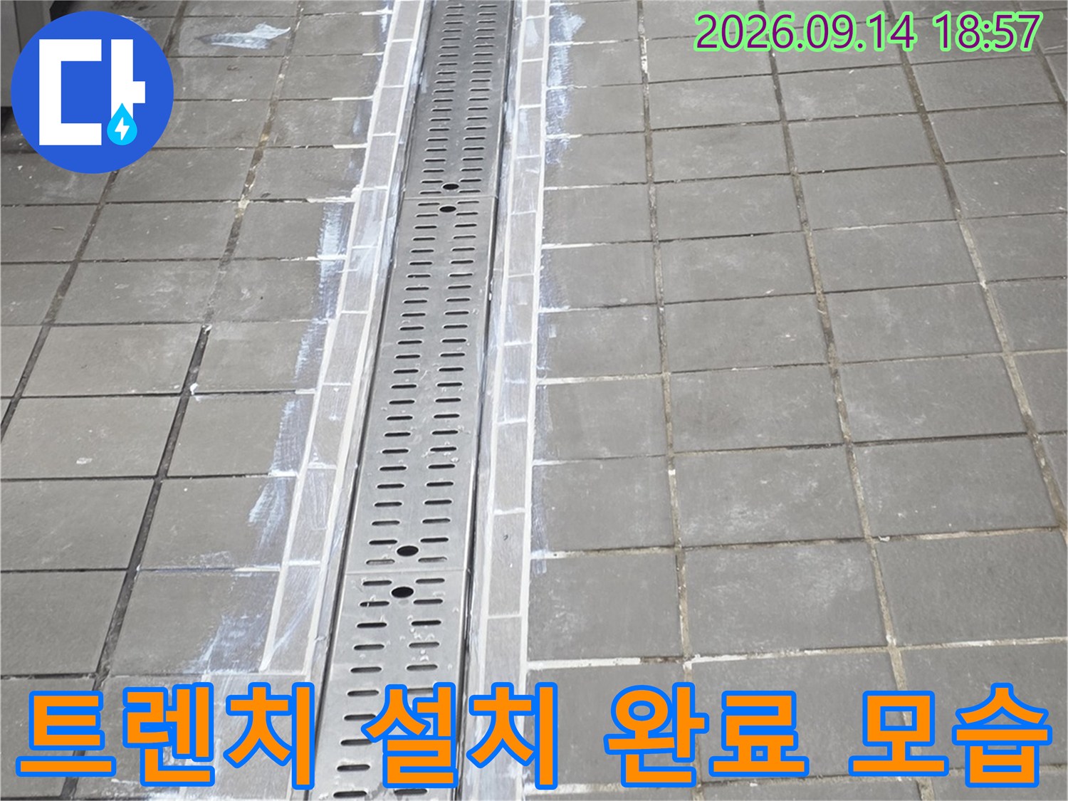 새로 시공된 스테인리스 트렌치와 주변 타일 경계 마감