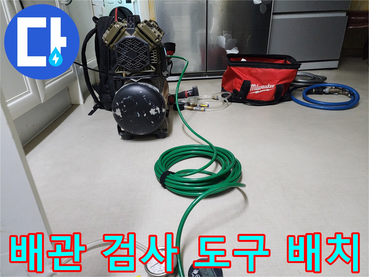 현장에서 사용 중인 공압 테스트용 압력계와 호스 뭉치